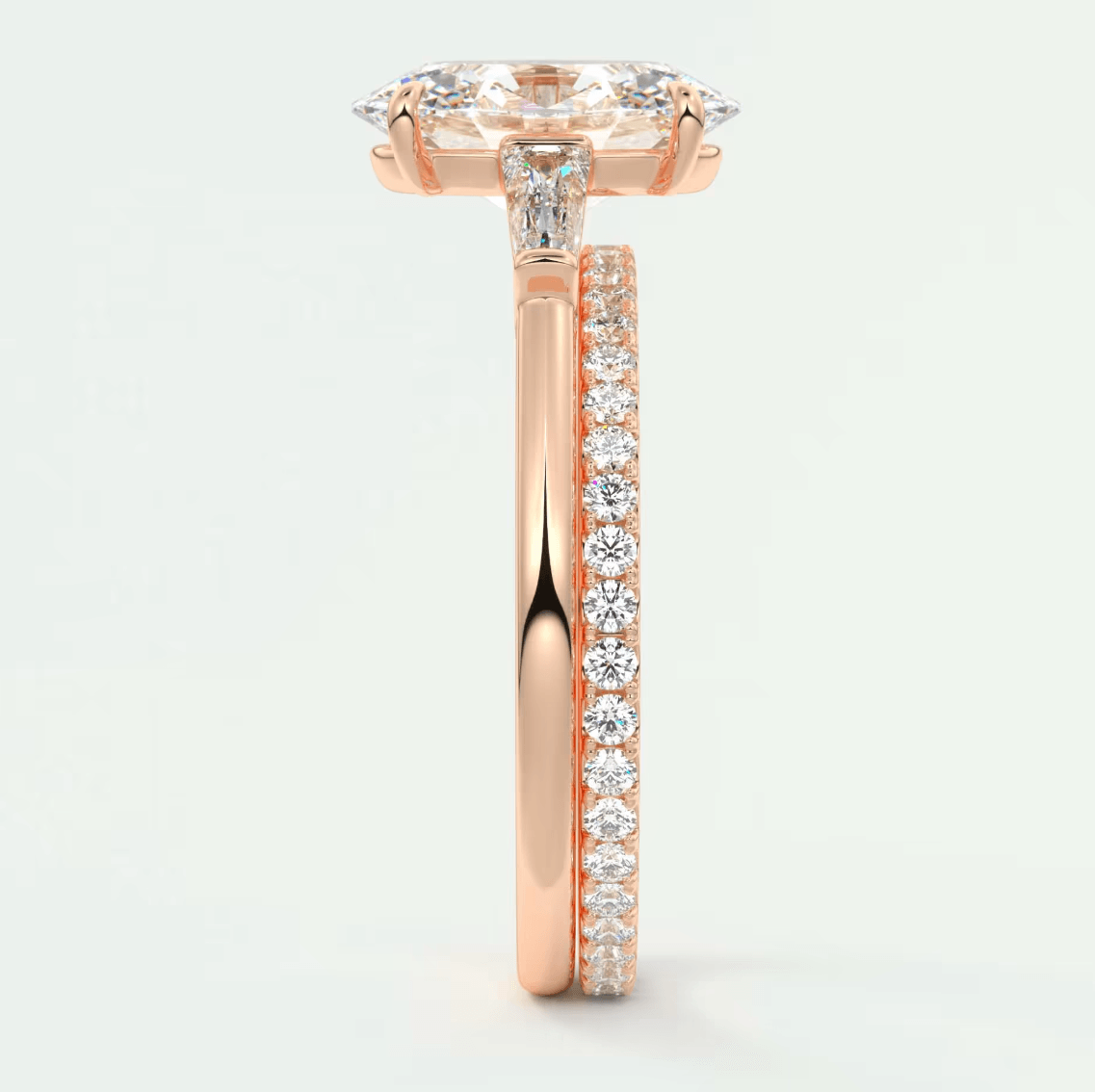 18k rose gold engagement ring with a marquise-cut diamond center stone and pavé set diamonds on the band.