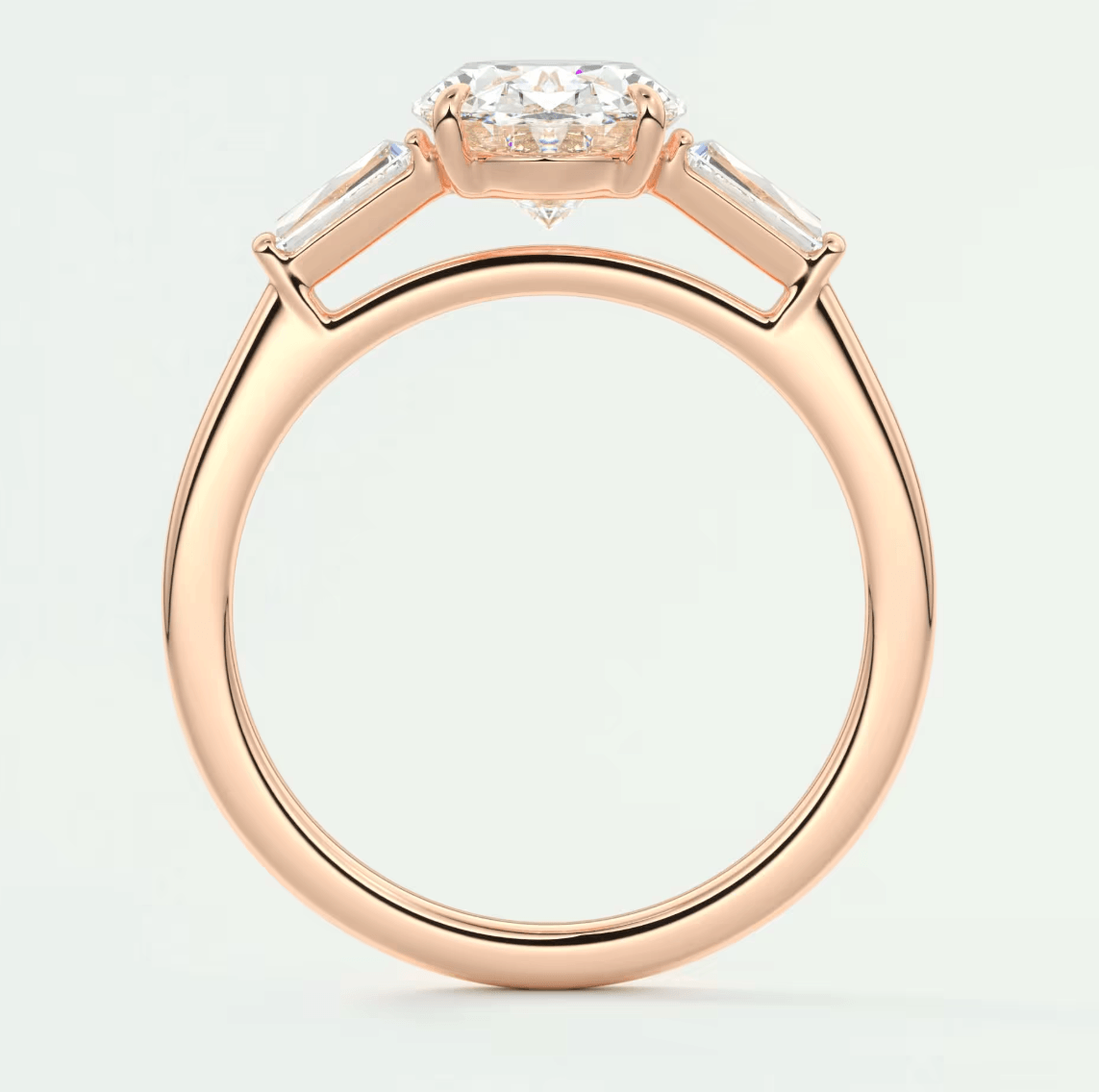 Rose gold diamond engagement ring with baguette accents and a halo setting.