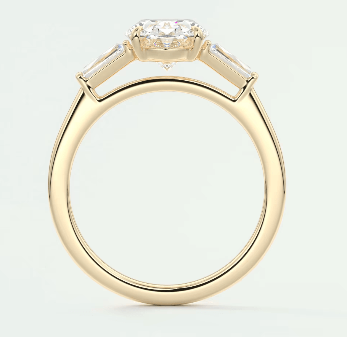 18k yellow gold engagement ring with a marquise-cut diamond and baguette diamonds, featuring an elegant design.