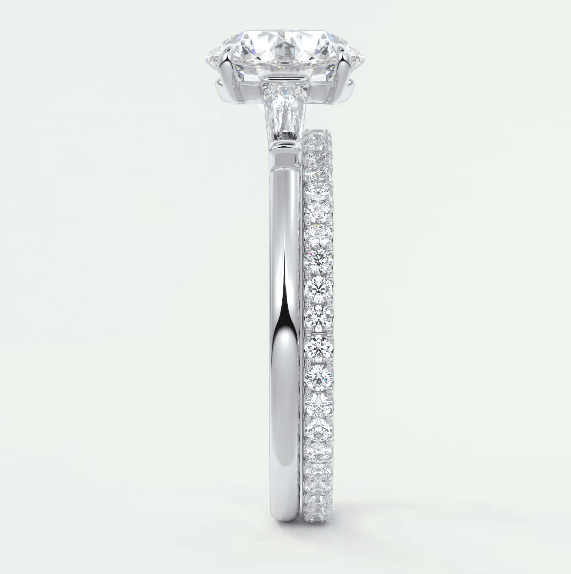 18-karat white gold diamond engagement ring with a cushion-cut center stone and pavé set diamonds on the band.