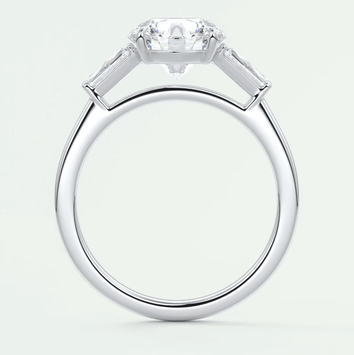 White gold engagement ring with baguette diamonds and a central round diamond.