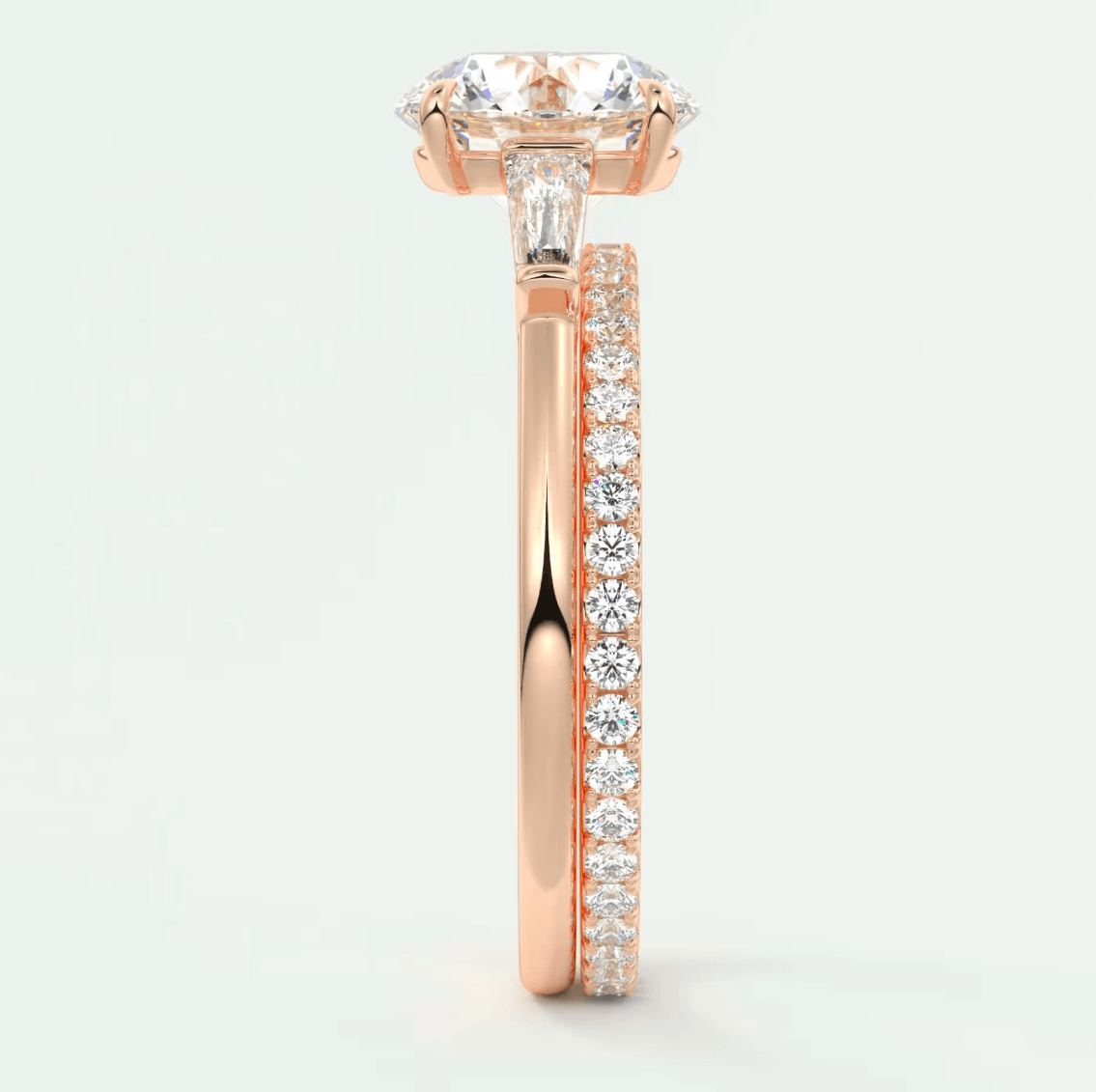 Rose gold diamond engagement ring with a cushion-cut center stone and side pavé diamonds.