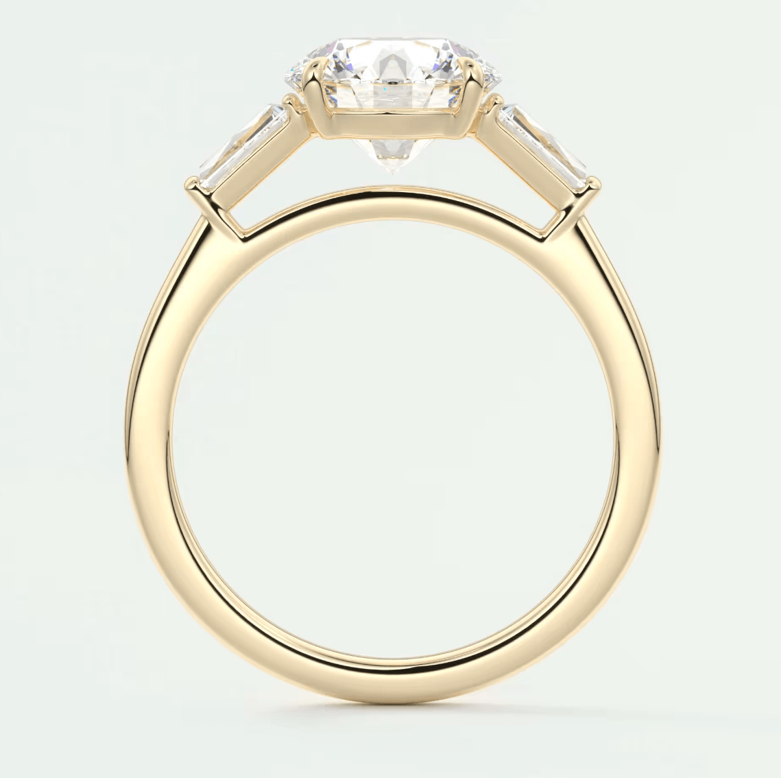 18-karat yellow gold engagement ring with a cushion-cut diamond and baguette diamonds, featuring a classic solitaire design.