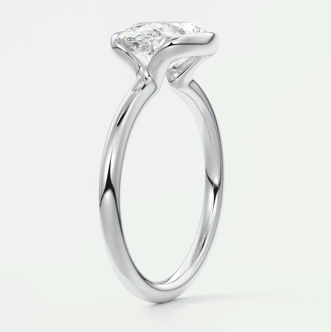 18-karat white gold engagement ring with a princess-cut diamond.