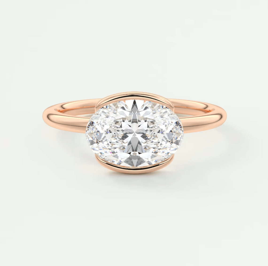 Rose gold oval diamond engagement ring with a solitaire design.