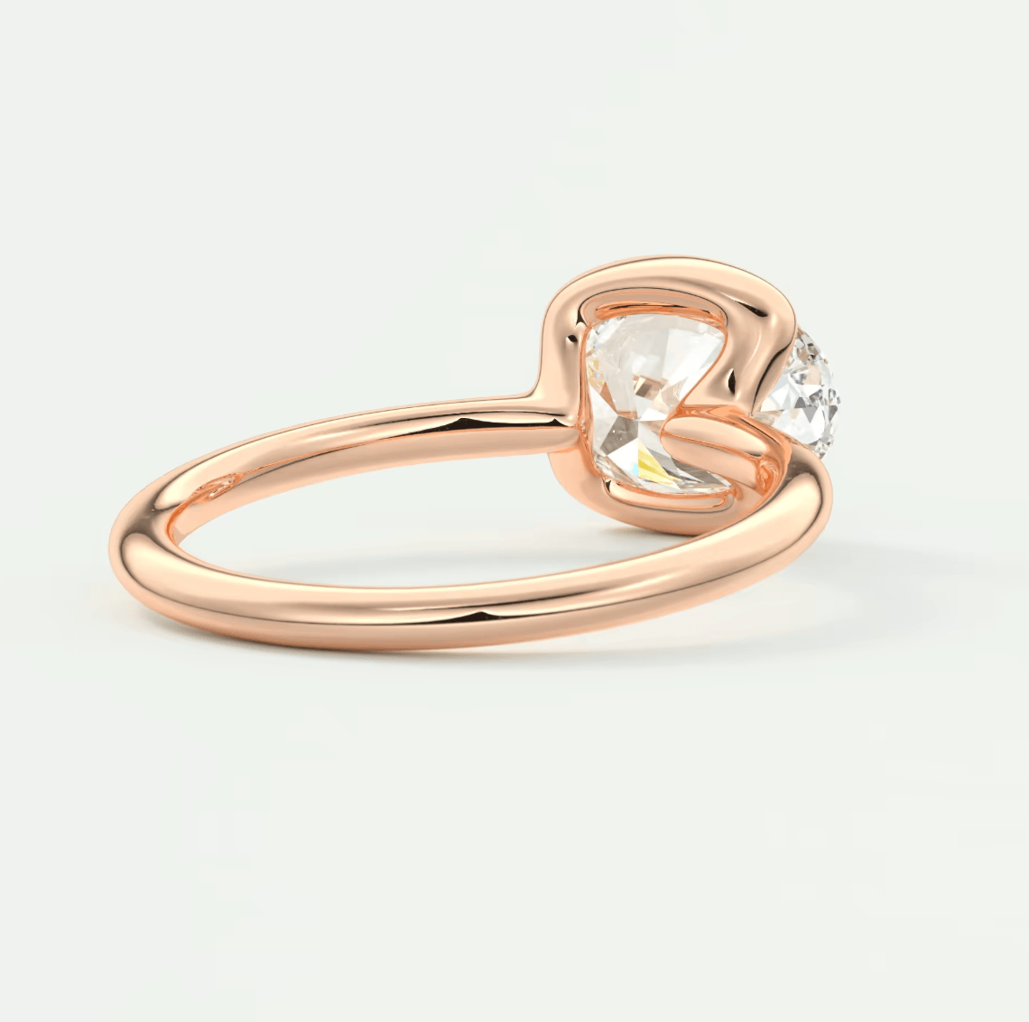 Rose gold heart-shaped diamond engagement ring with a single stone.