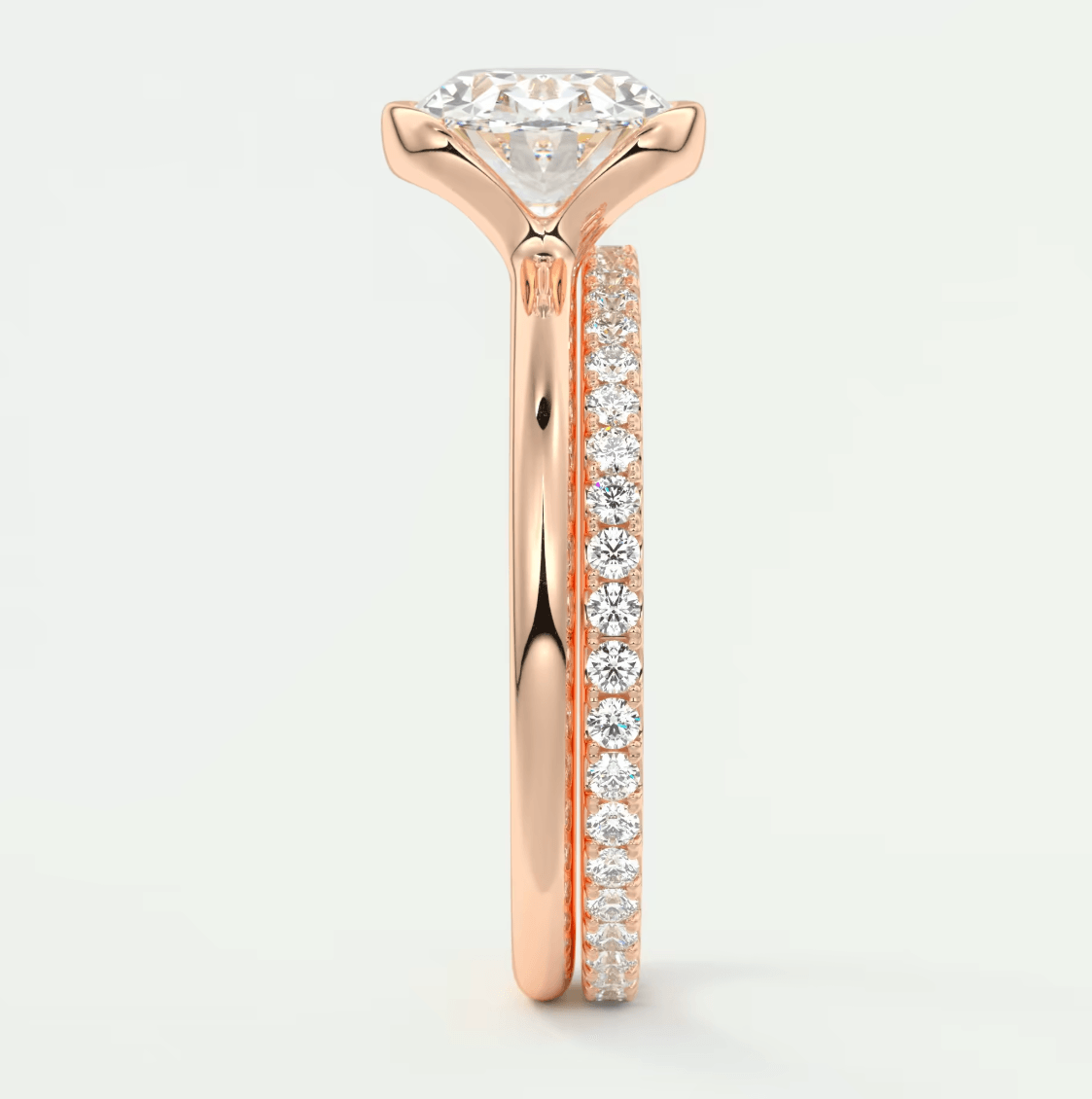 18k rose gold diamond engagement ring with a round brilliant cut center stone and channel set diamonds on the band.