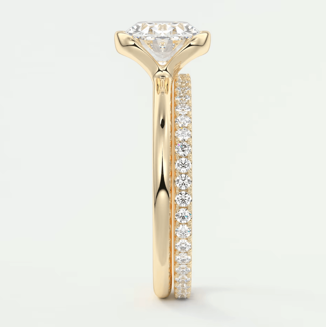 18k yellow gold diamond engagement ring with a round brilliant cut center stone and pave set diamonds on the band.