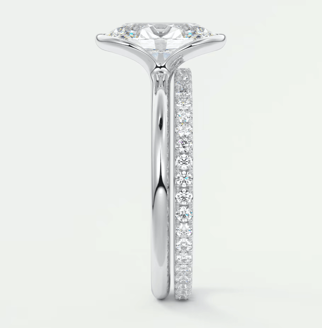 18k white gold diamond engagement ring with a round brilliant cut center stone and pave set diamonds on the band.