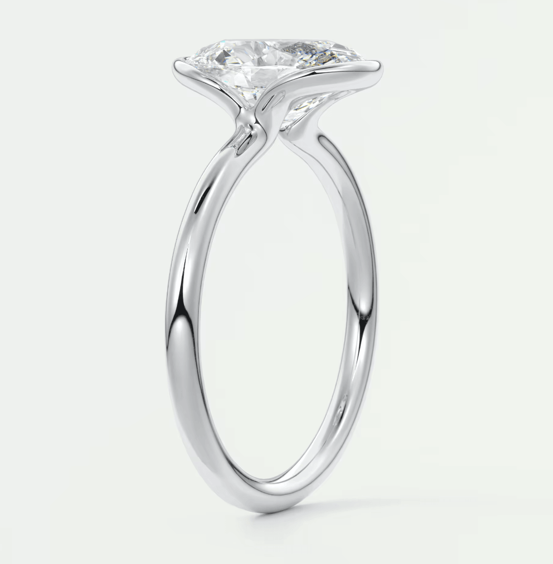 18k white gold solitaire diamond engagement ring with a round brilliant cut stone.