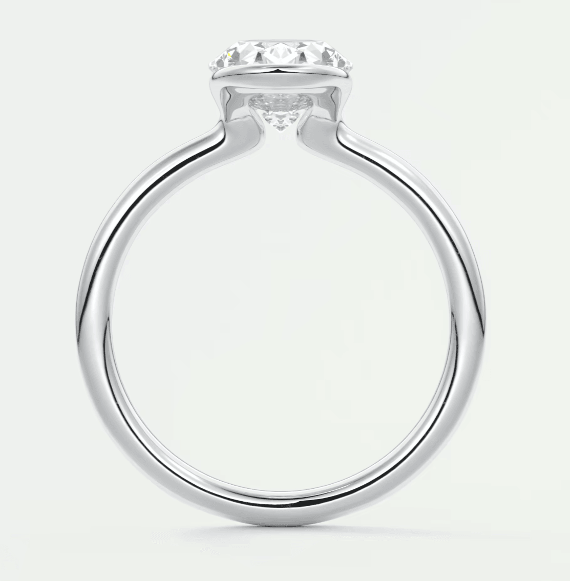 White gold solitaire diamond engagement ring with a round brilliant cut stone.