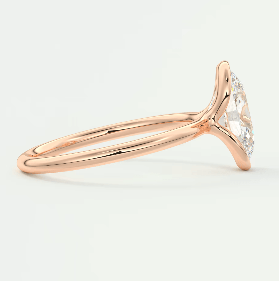 18k rose gold halo engagement ring with a marquise-cut diamond center stone and small diamonds on the band.