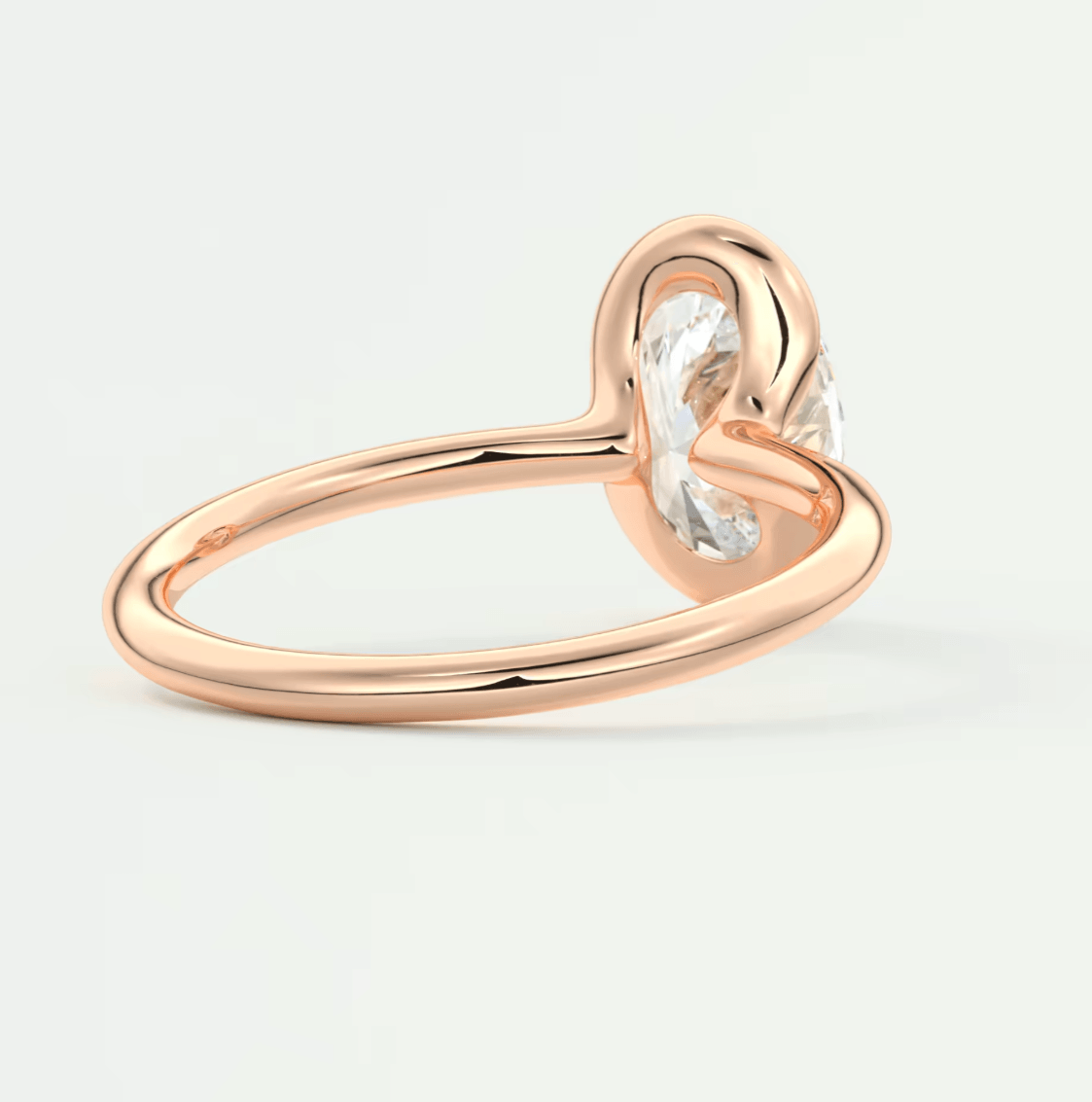 Rose gold heart-shaped diamond engagement ring with a single large stone.