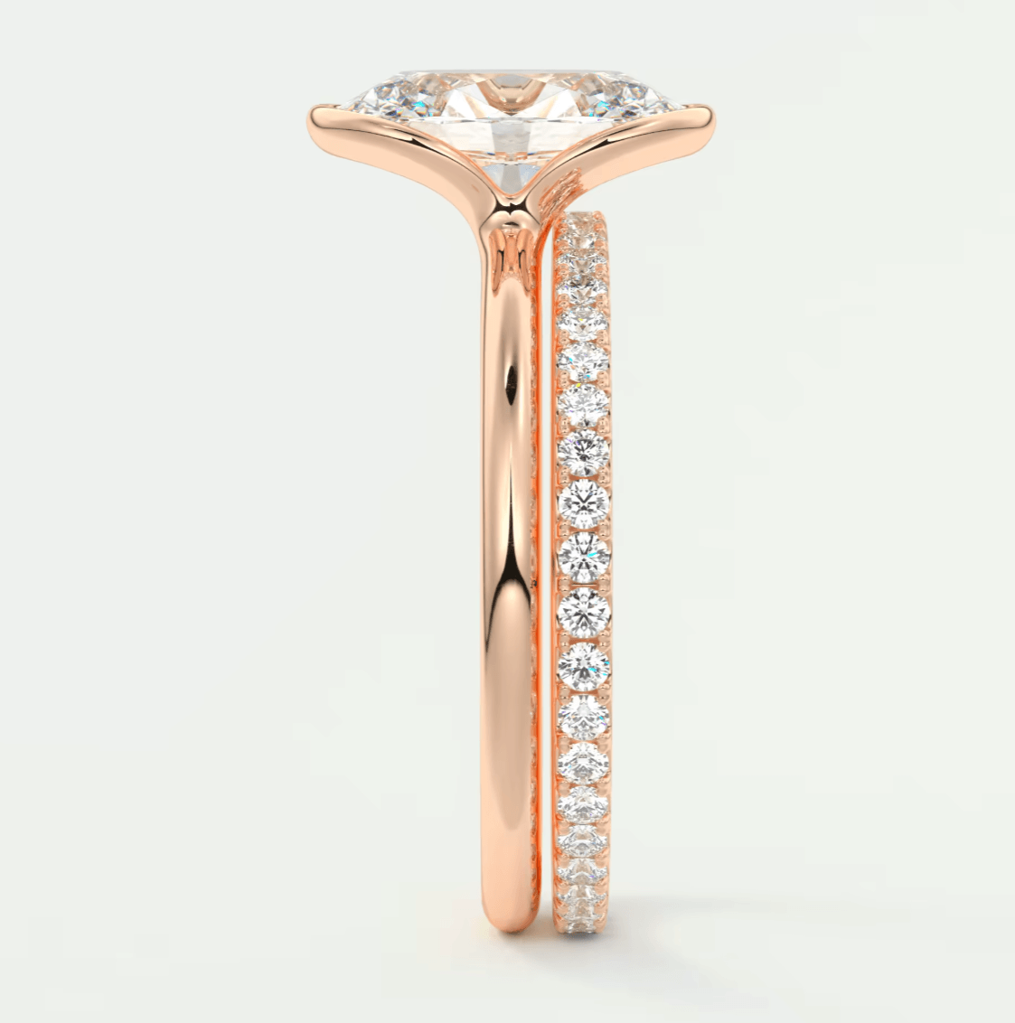 18-karat rose gold engagement ring with a marquise-cut diamond and channel-set diamonds on the band.