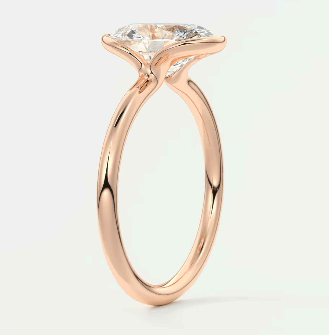 Rose gold engagement ring with a large, round diamond center stone.