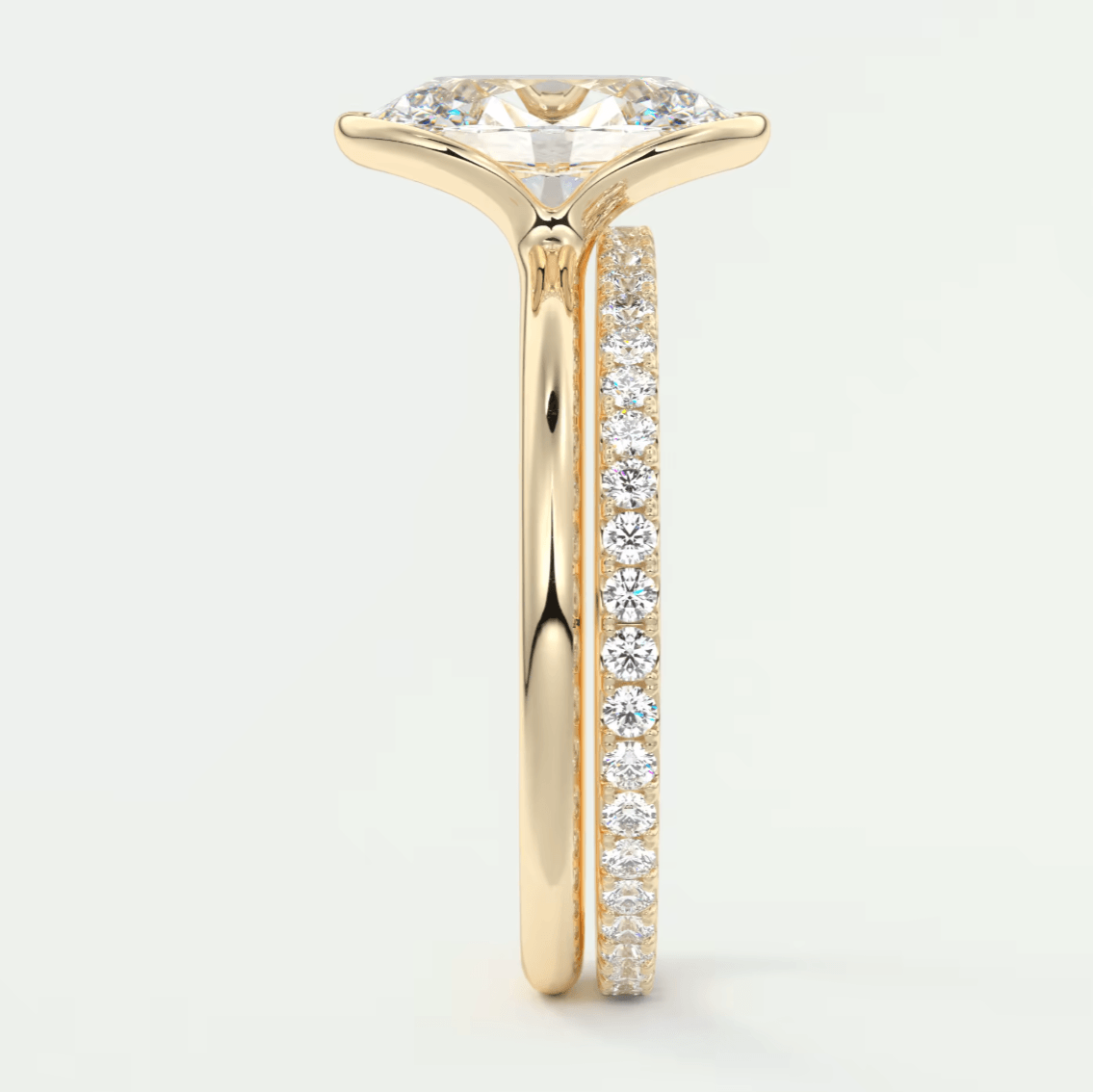 18k yellow gold engagement ring with a marquise-cut diamond and pave set diamonds on the band.