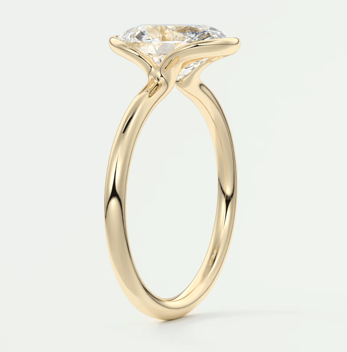 18-karat yellow gold engagement ring with a large, round diamond.