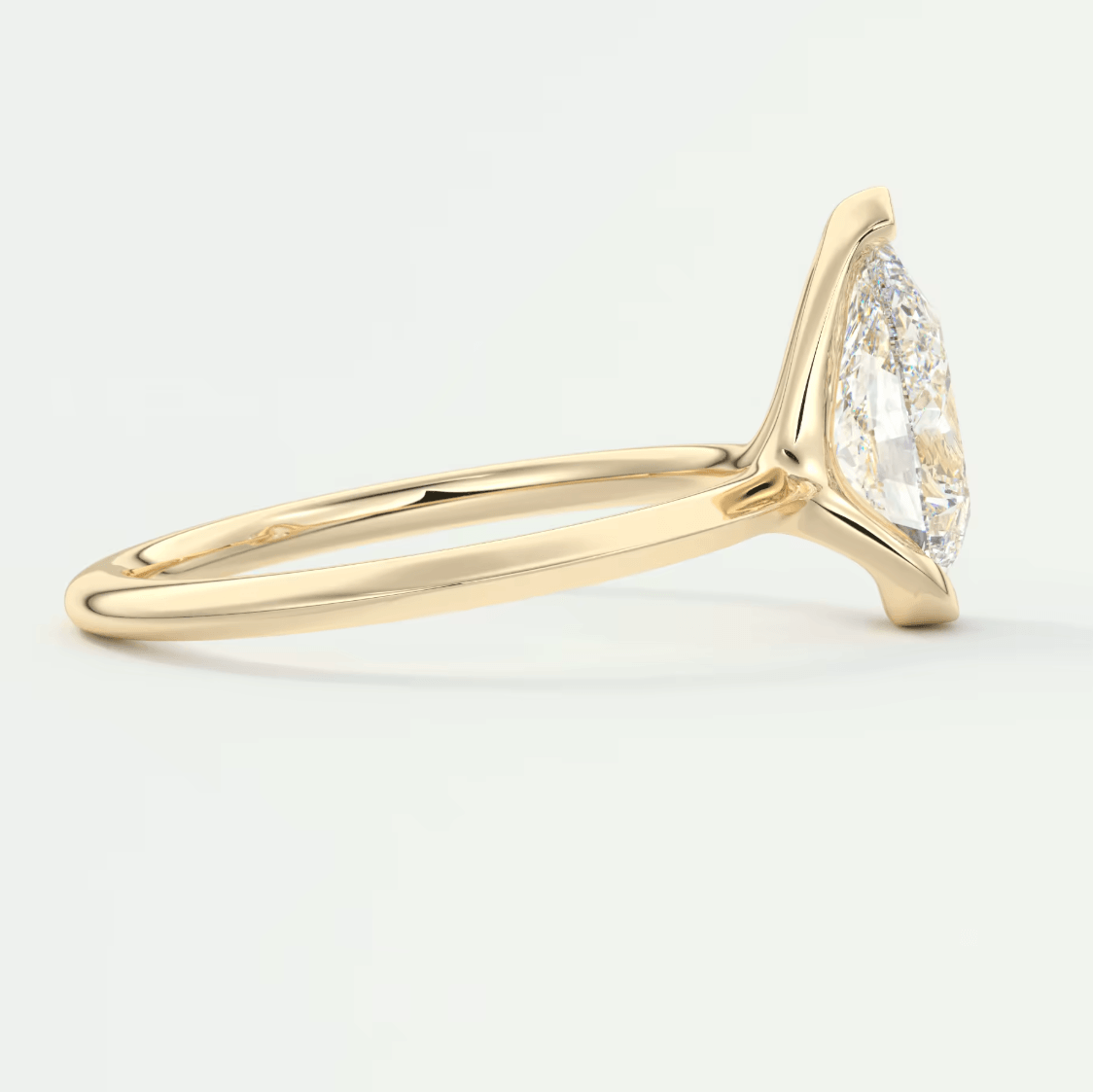 18k yellow gold marquise diamond engagement ring with a halo of smaller diamonds.