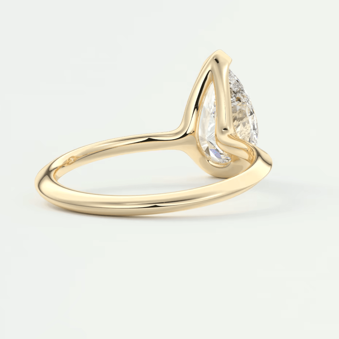 18k yellow gold pear-shaped diamond engagement ring.