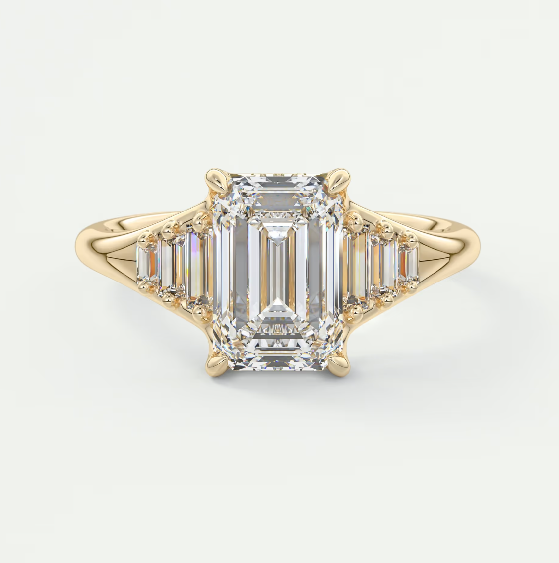 Solena Emerald Split Shank Engagement Ring with Graduated Baguette Side Stones