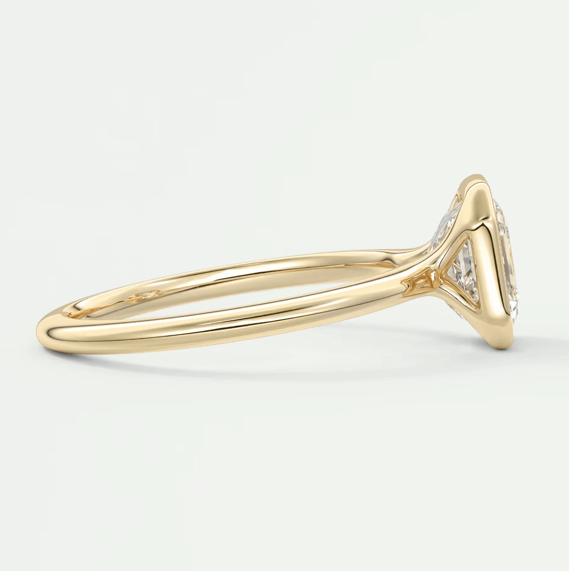 18k yellow gold diamond engagement ring with a marquise-cut center stone and small diamonds on the band.