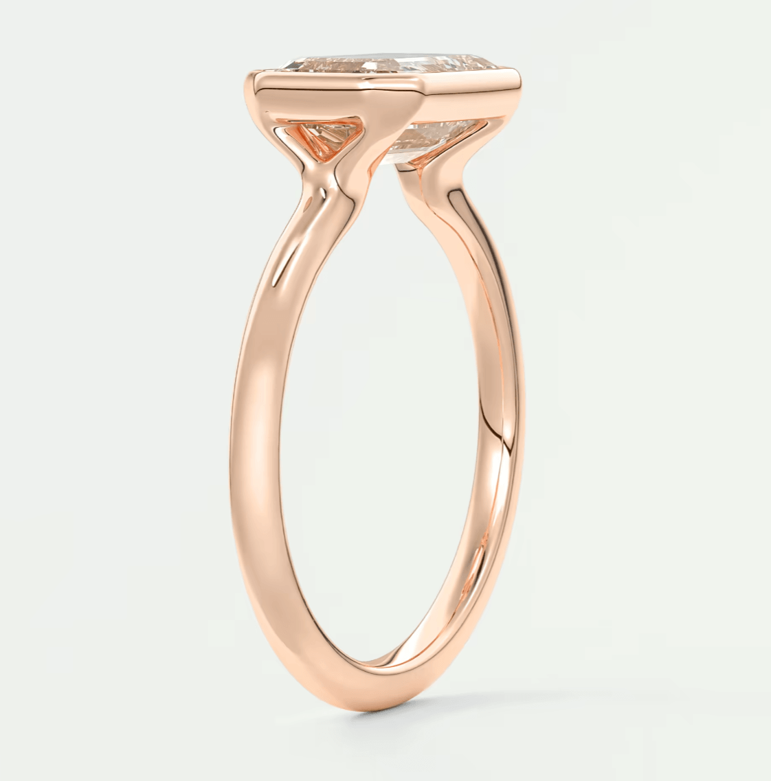 18-karat rose gold engagement ring with a cushion-cut diamond.