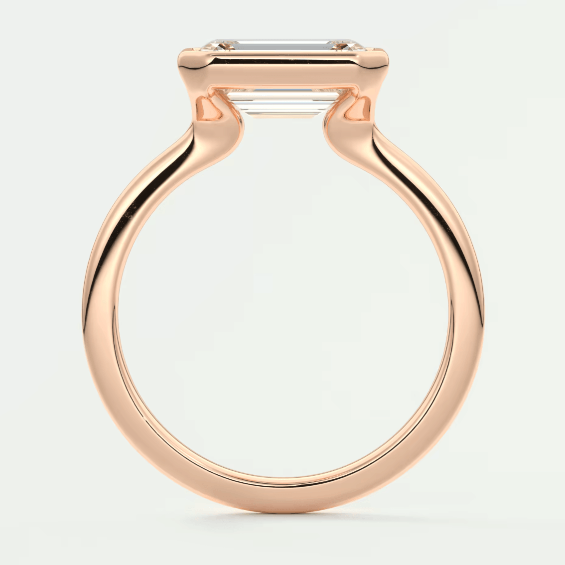 Rose gold emerald cut diamond engagement ring with a sleek, modern design.