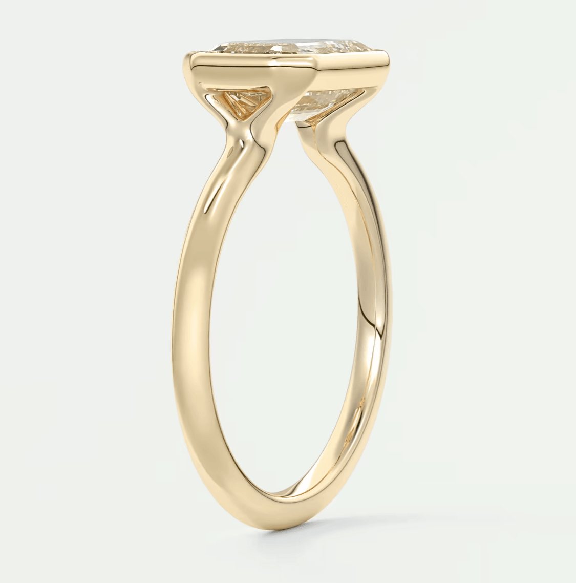 18k yellow gold engagement ring with a cushion-cut diamond.