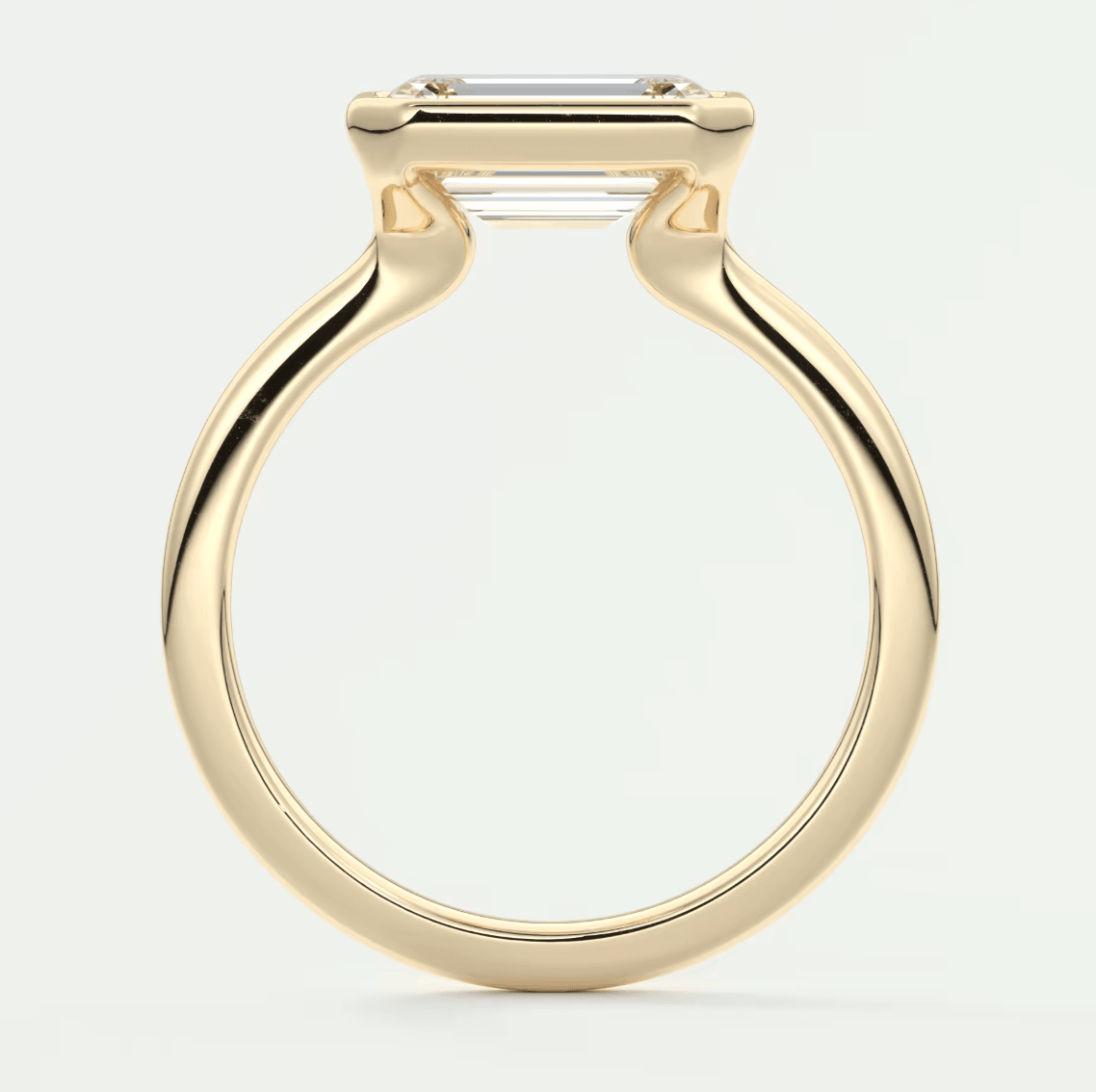 18k yellow gold engagement ring with an emerald-cut diamond.