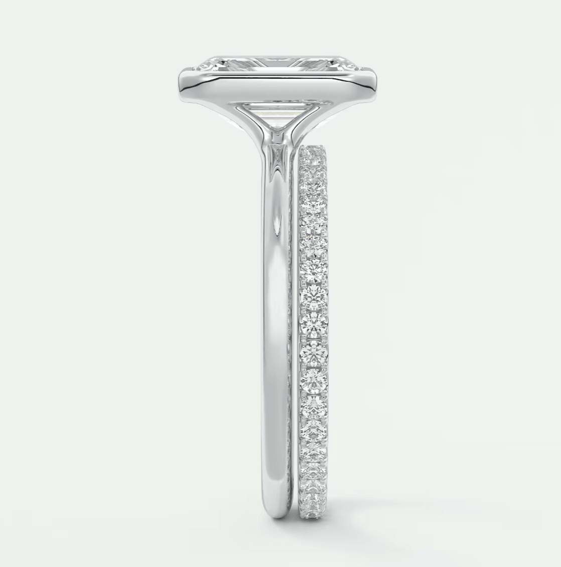 18k white gold diamond engagement ring with a princess cut center stone and channel set diamonds on the band.