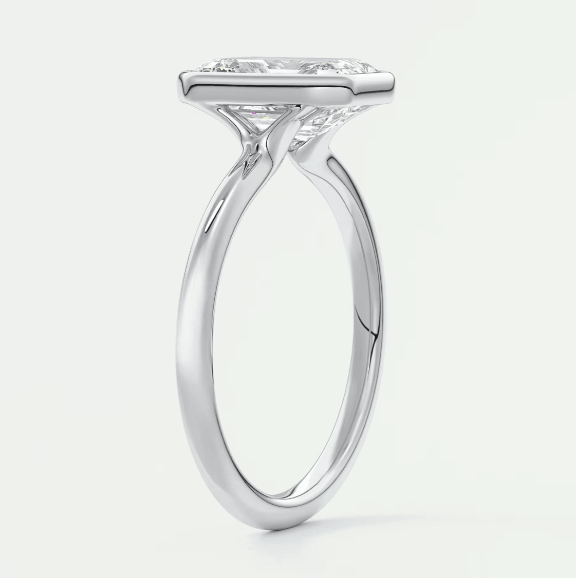 White gold solitaire engagement ring with a princess cut diamond.