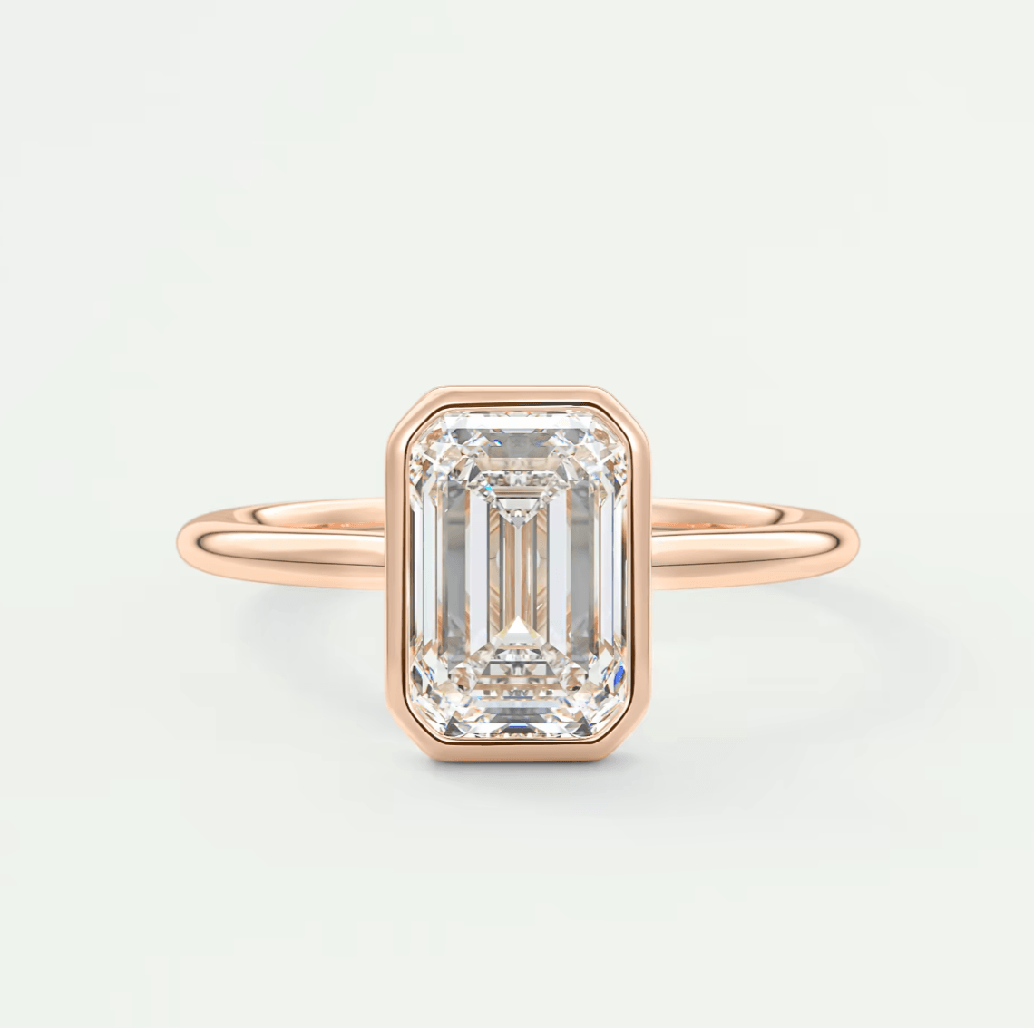 18-karat rose gold emerald-cut diamond engagement ring.