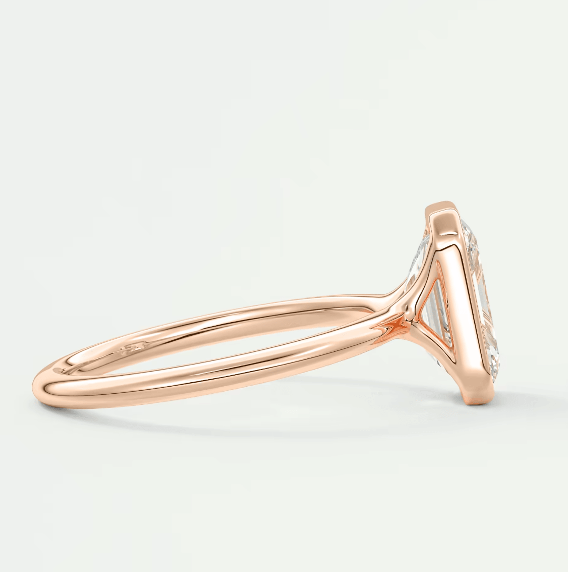 18-karat rose gold engagement ring with a marquise-cut diamond.