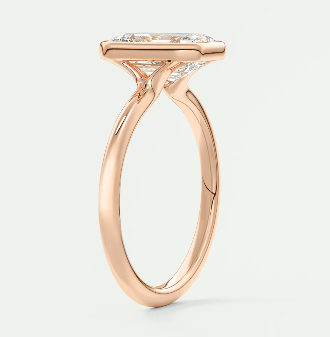 18-karat rose gold engagement ring with a princess-cut diamond.