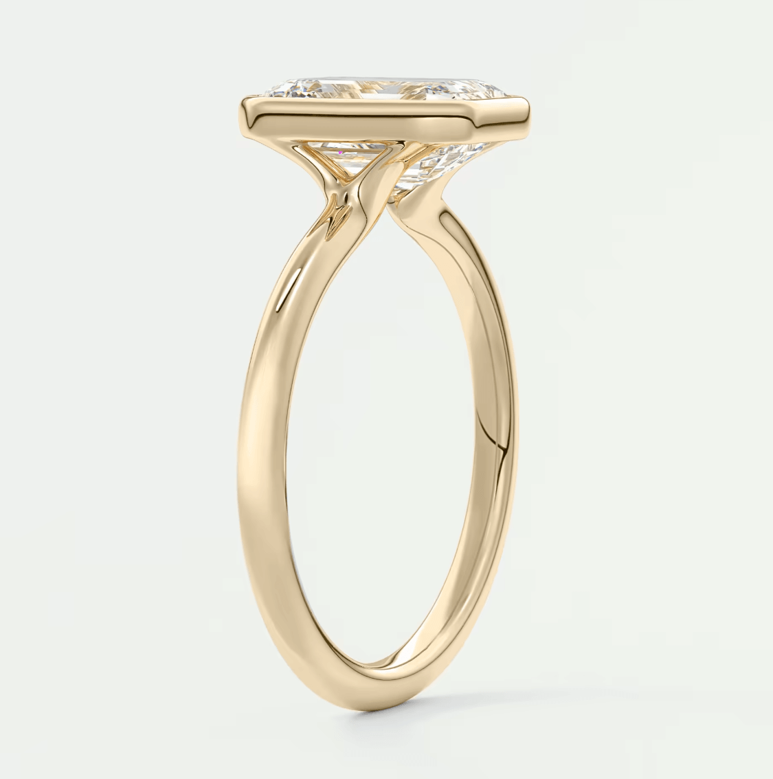 18-karat yellow gold engagement ring with a princess-cut diamond.