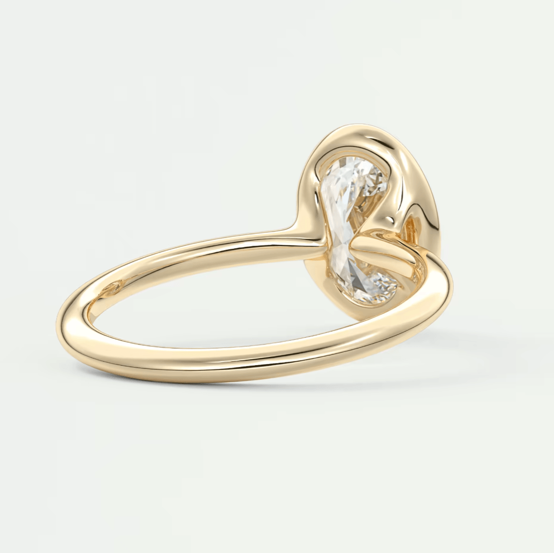 Gold heart-shaped diamond engagement ring with a single large stone.