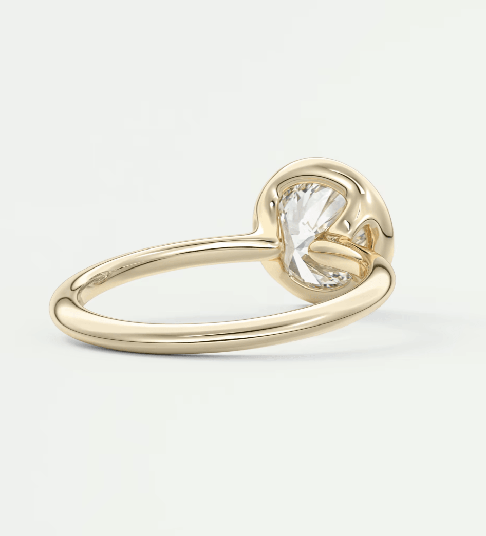 18-karat gold engagement ring with a heart-shaped diamond.