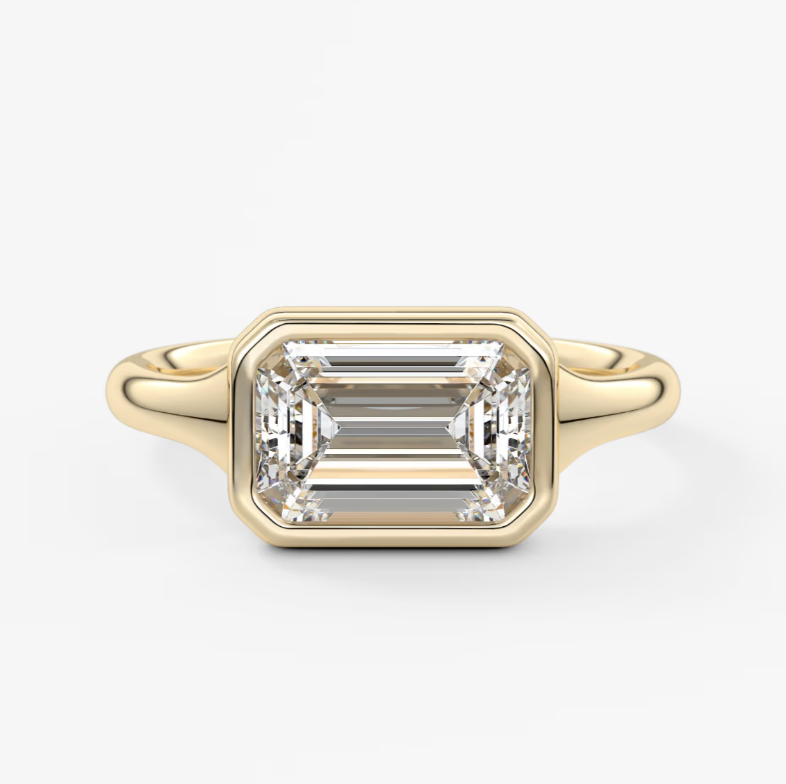 18-karat yellow gold emerald-cut diamond engagement ring.