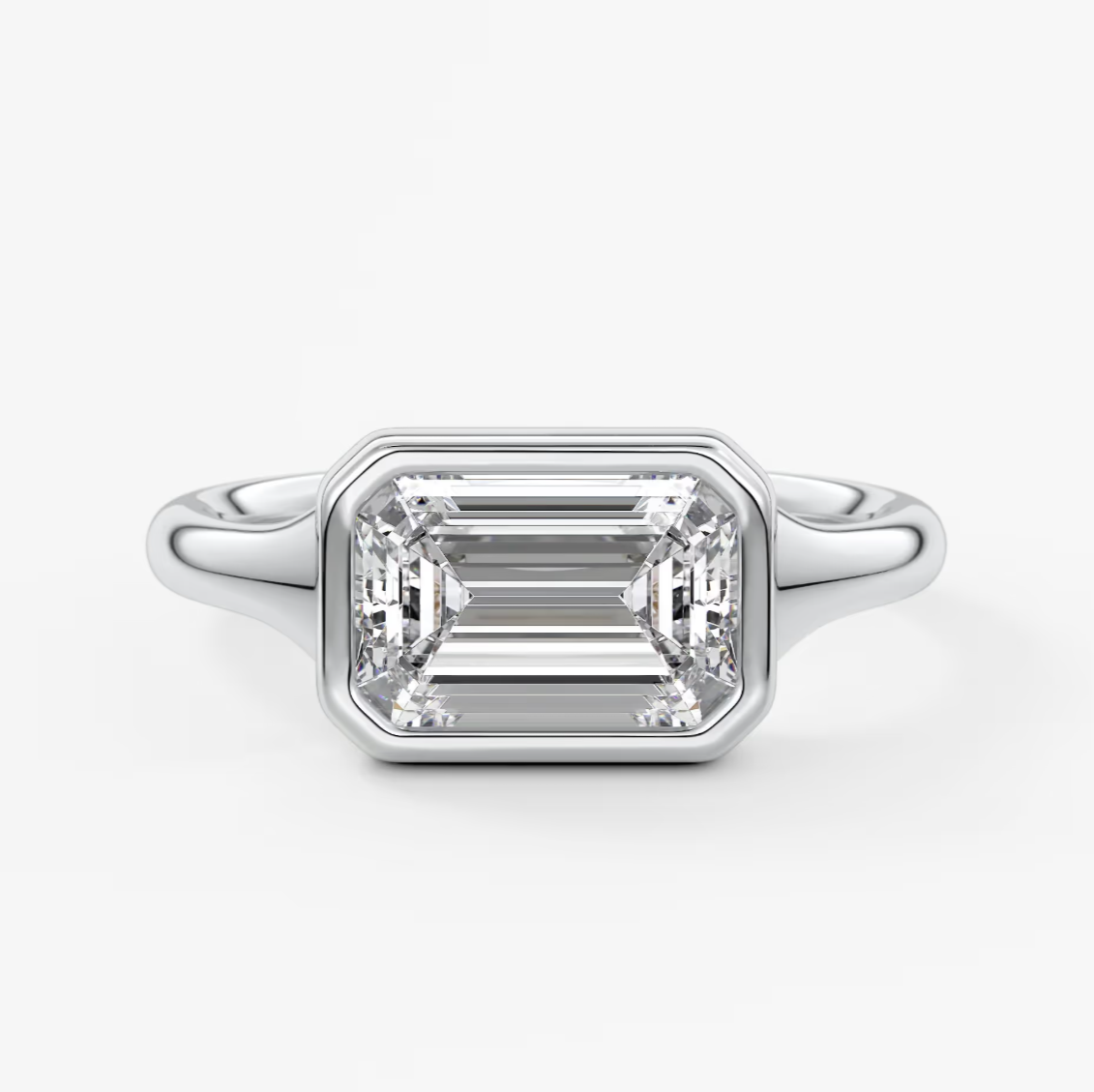 18k white gold emerald cut diamond engagement ring with baguette side stones.