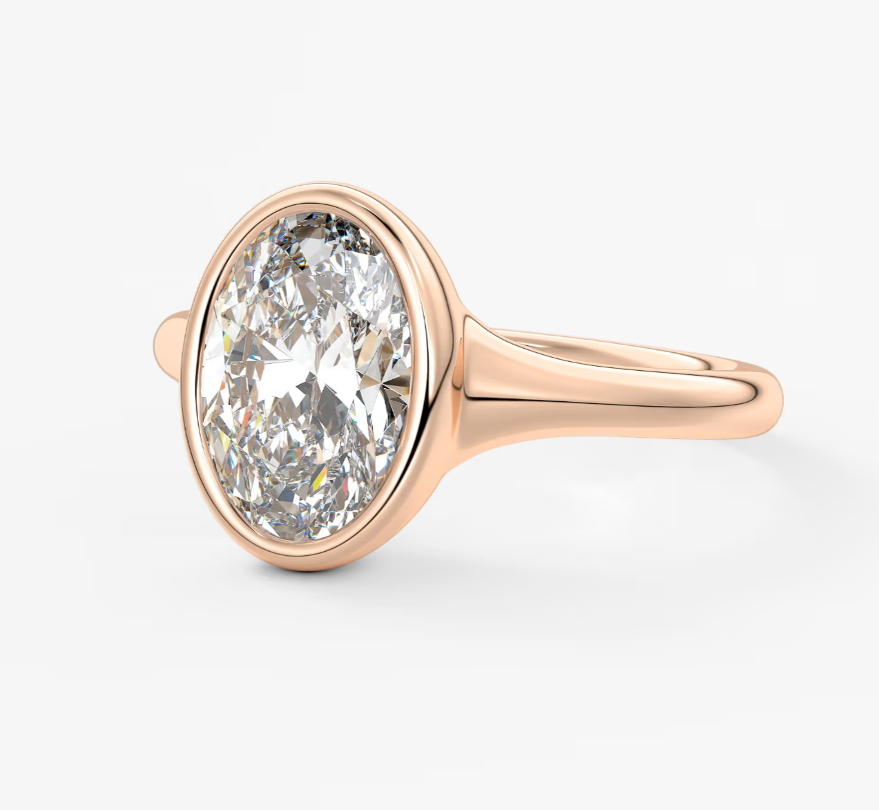 18-karat rose gold diamond engagement ring with a bezel setting.