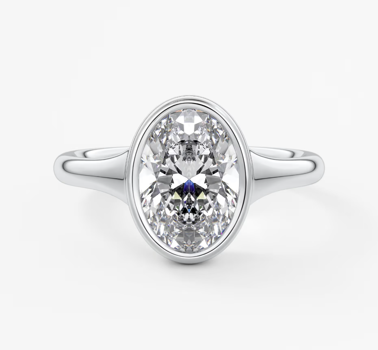 18-karat white gold engagement ring with a marquise-cut diamond and sapphire accent.