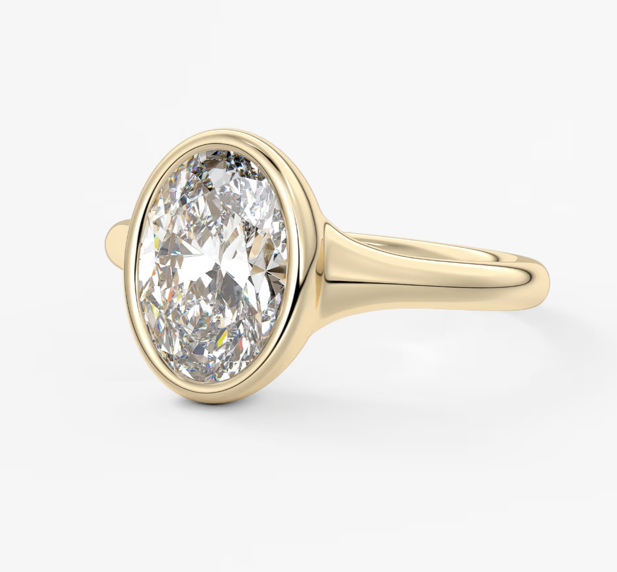 18-karat yellow gold diamond engagement ring with a bezel setting.
