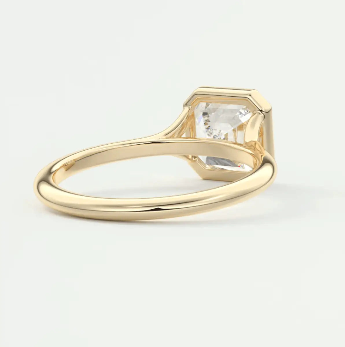 18-karat gold engagement ring with a princess-cut diamond.