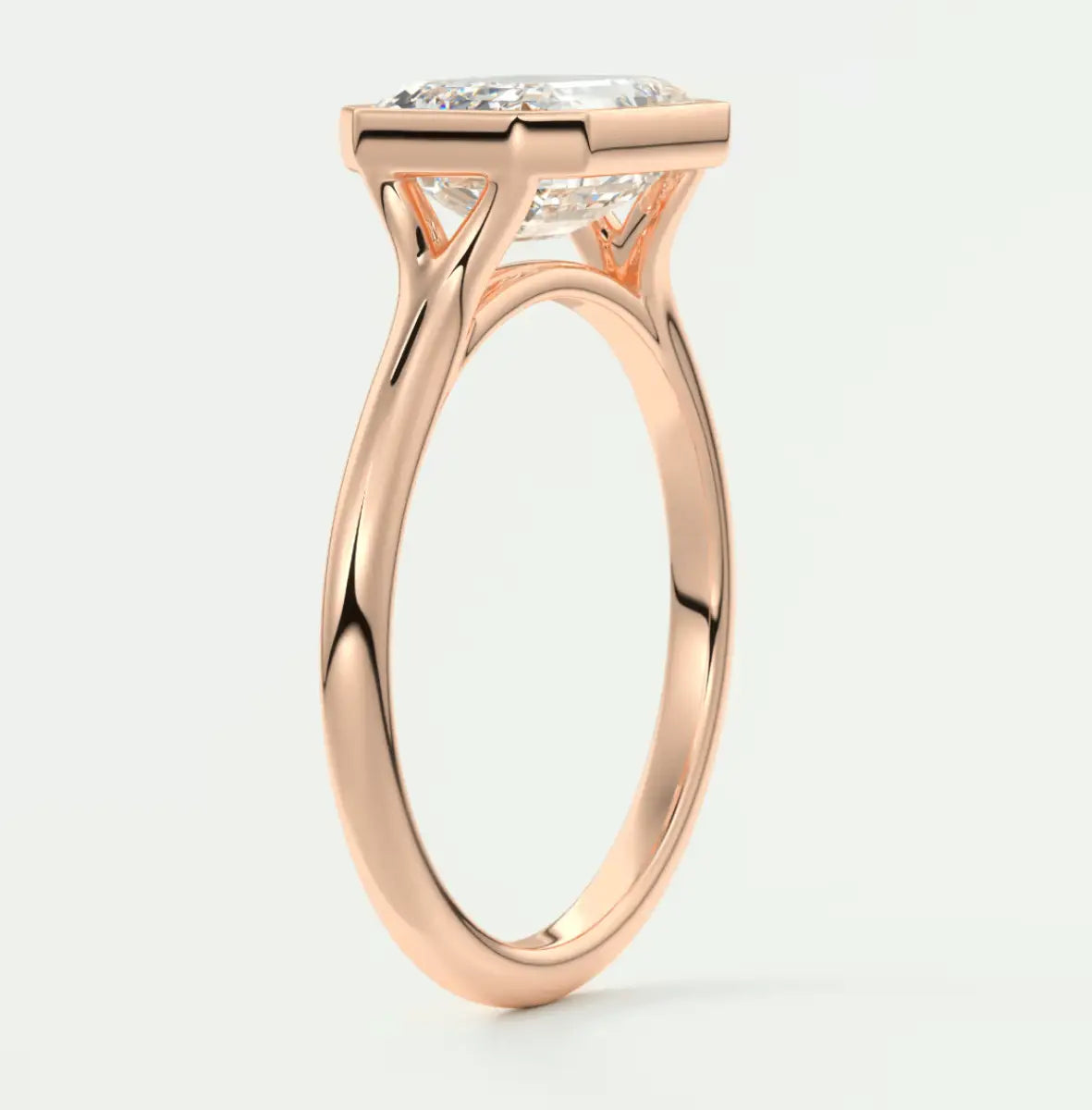 18k rose gold engagement ring with a cushion-cut diamond.