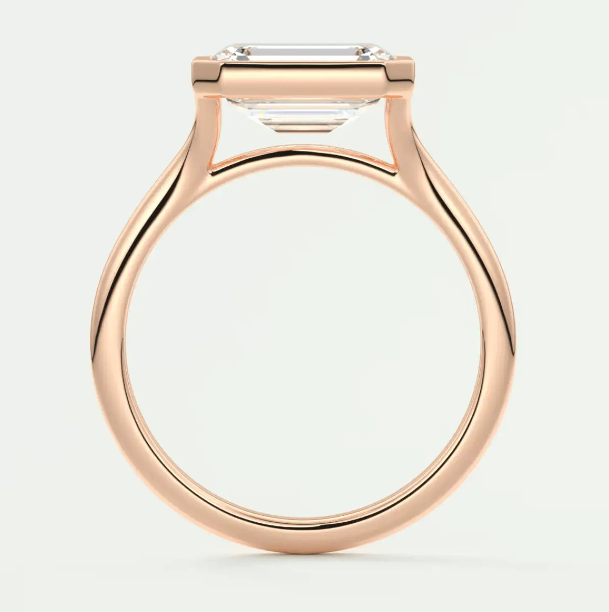 Rose gold engagement ring with emerald cut diamond