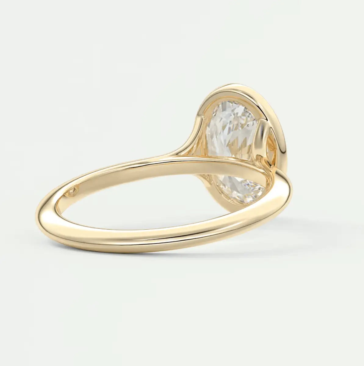 18k yellow gold engagement ring with a large oval diamond.