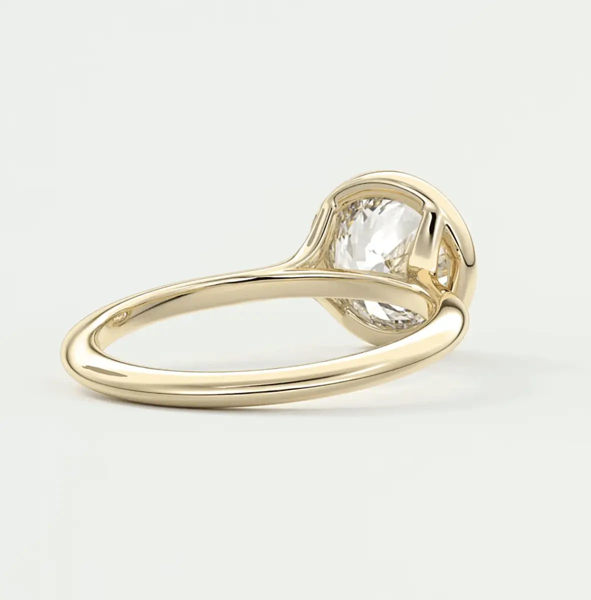 18k yellow gold engagement ring with a pear-shaped diamond.