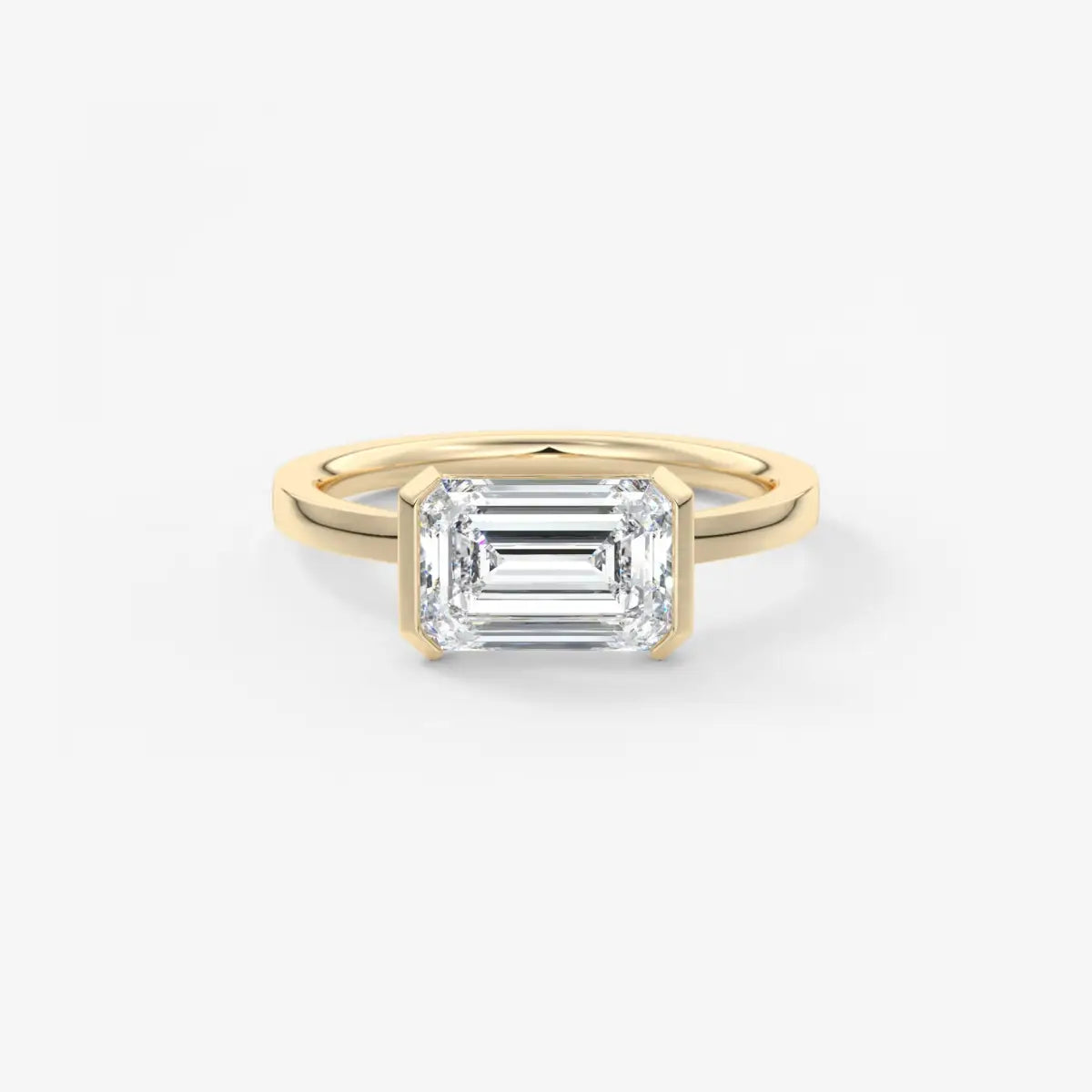 Gold ring with a rectangular diamond on a white background
