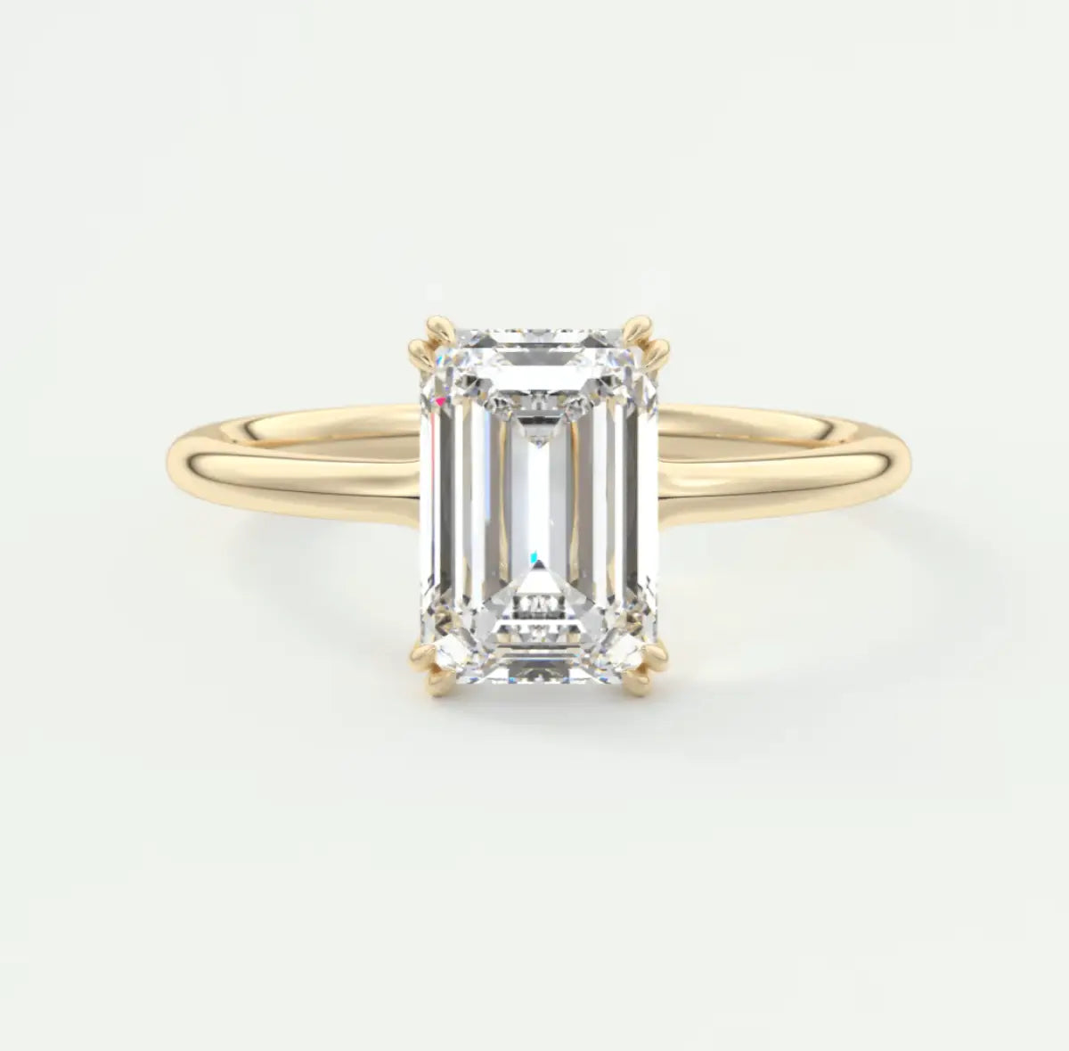 18-karat yellow gold emerald-cut diamond engagement ring.