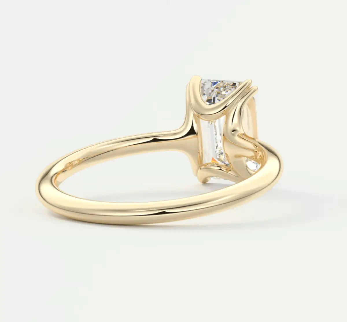 18k yellow gold engagement ring with a princess cut diamond and baguette side stones.